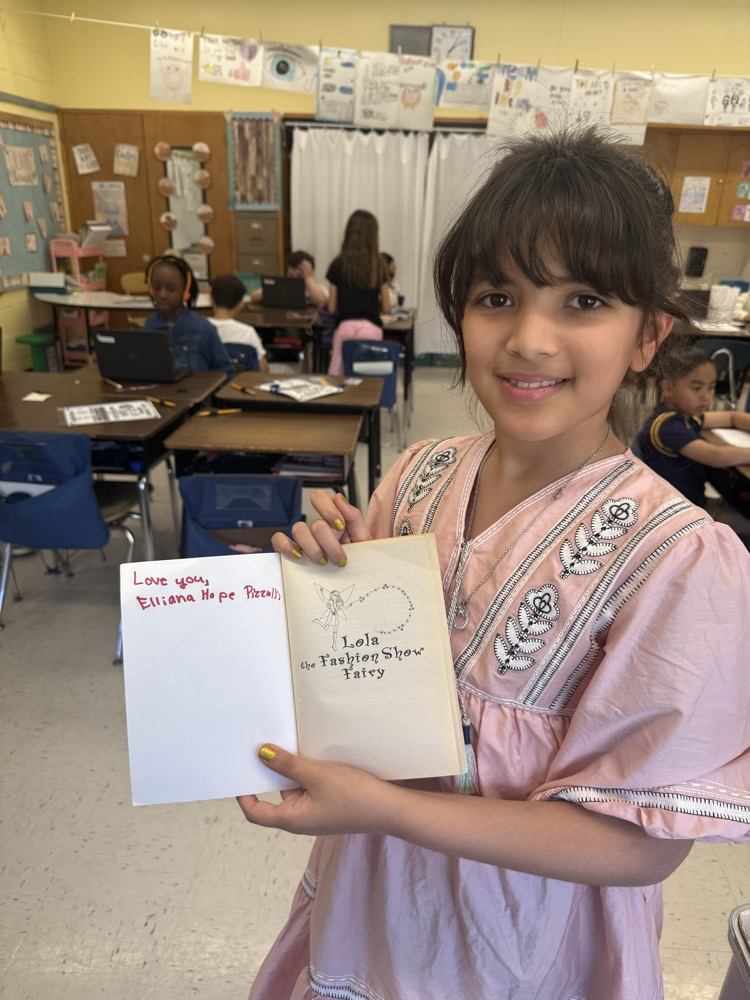 Student posing with a book