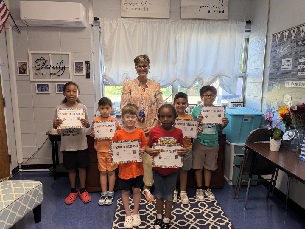 Sensational 7: students standing with certificates with their principal