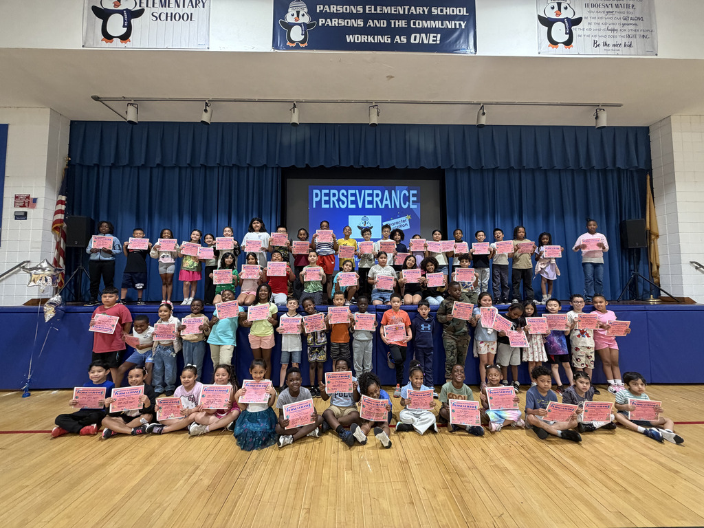 Students assembled holding pink certificates