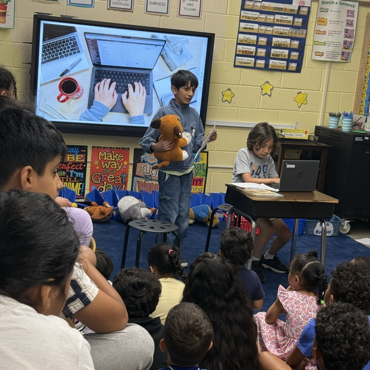 Students in a classroom sitting on the floor