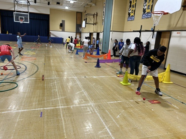Students playing games in a gymnasium