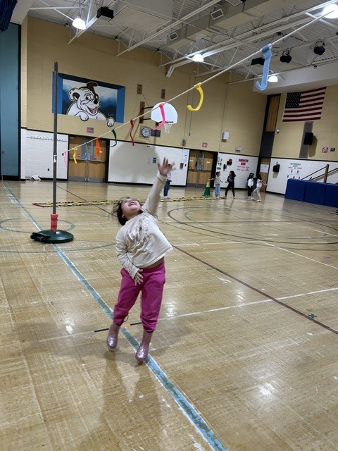 Students playing games in a gymnasium