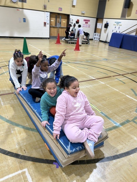 Students playing games in a gymnasium