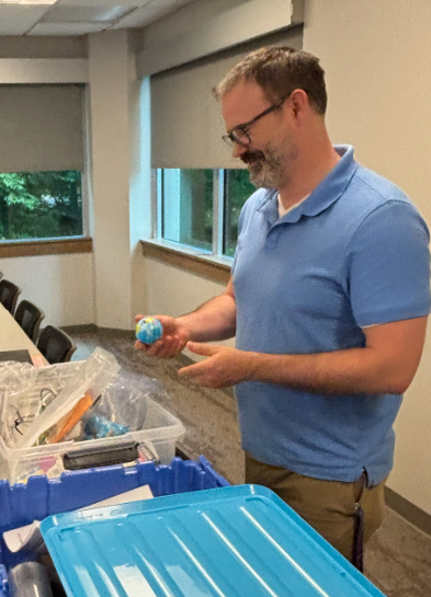 Science Teacher Checking Equipment