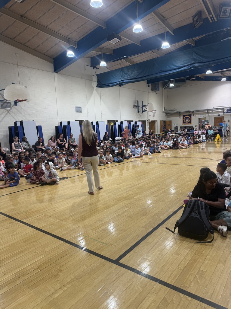 Staff member addressing kids in gym