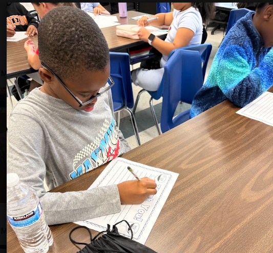 Student writing thank you letters