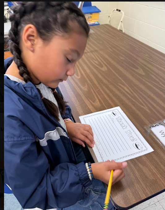 Student writing thank you letters