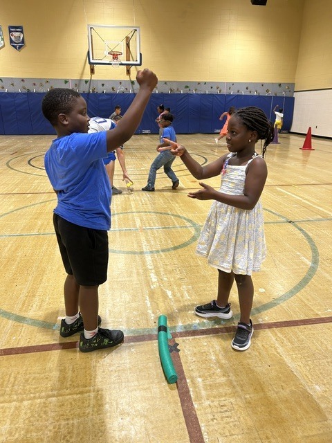 Students playing rock paper scissors