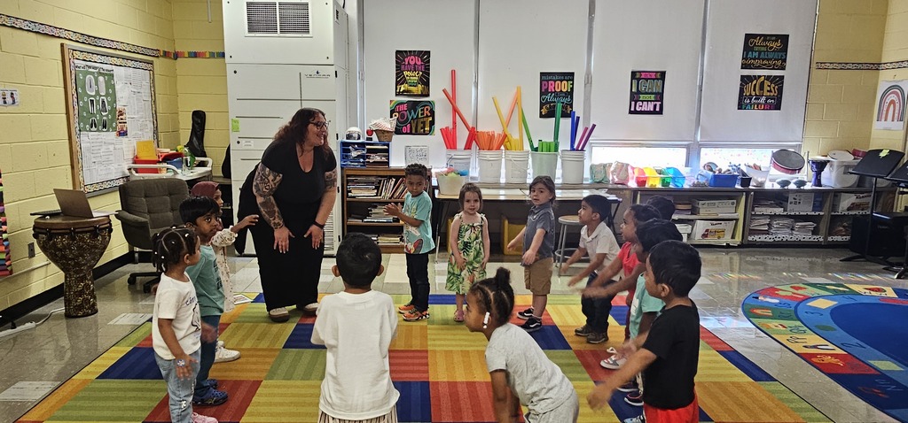 pre k music class of students with their teacher