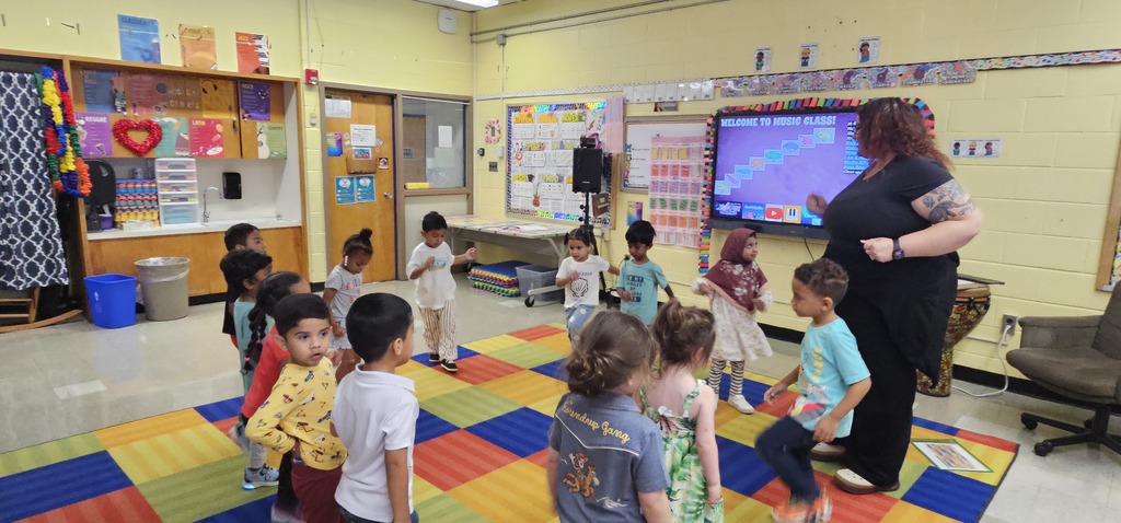 pre k music class of students with their teacher