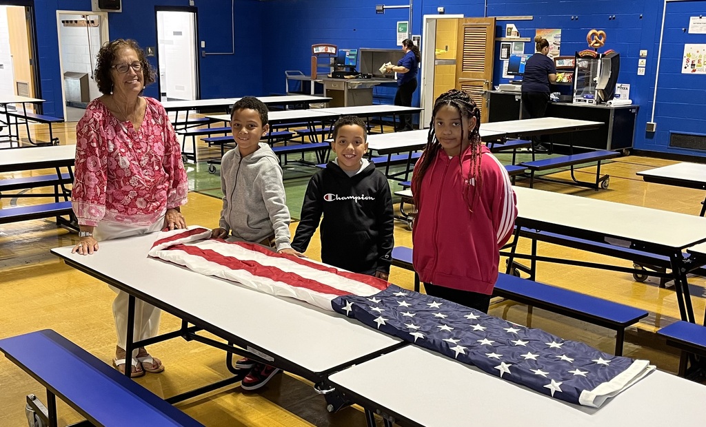 Flag Raiser Students standing at the table