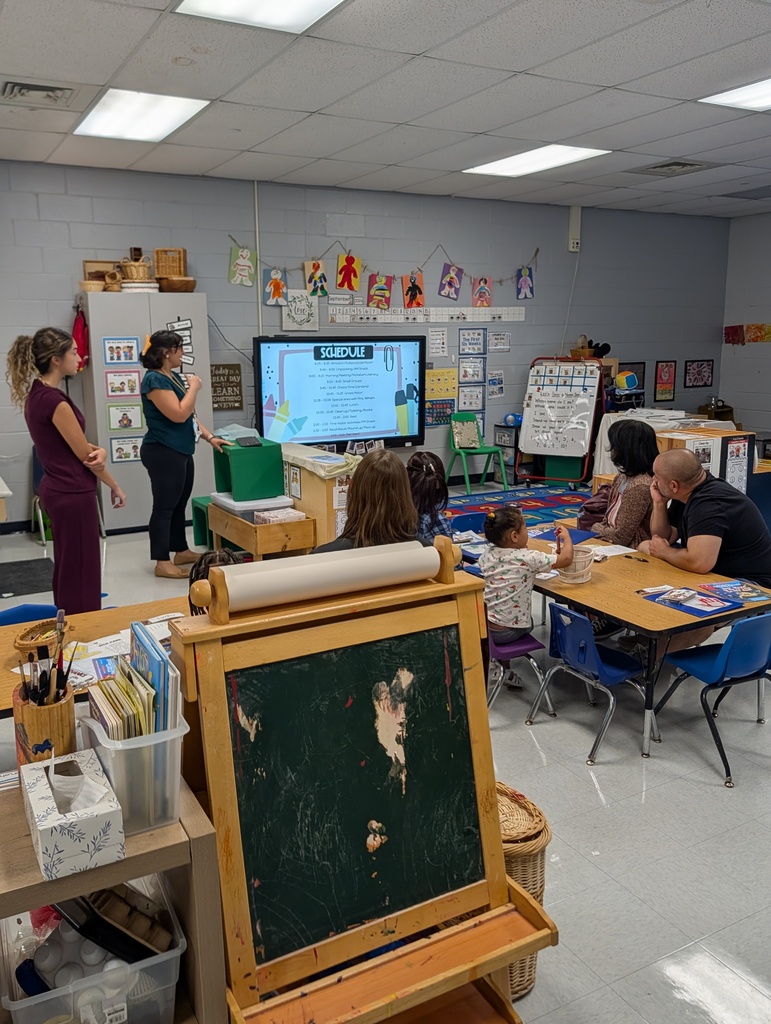 Teachers talking to parents in a classroom
