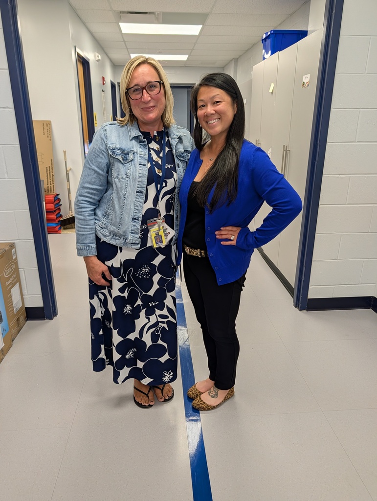 Two teachers together in the hallway