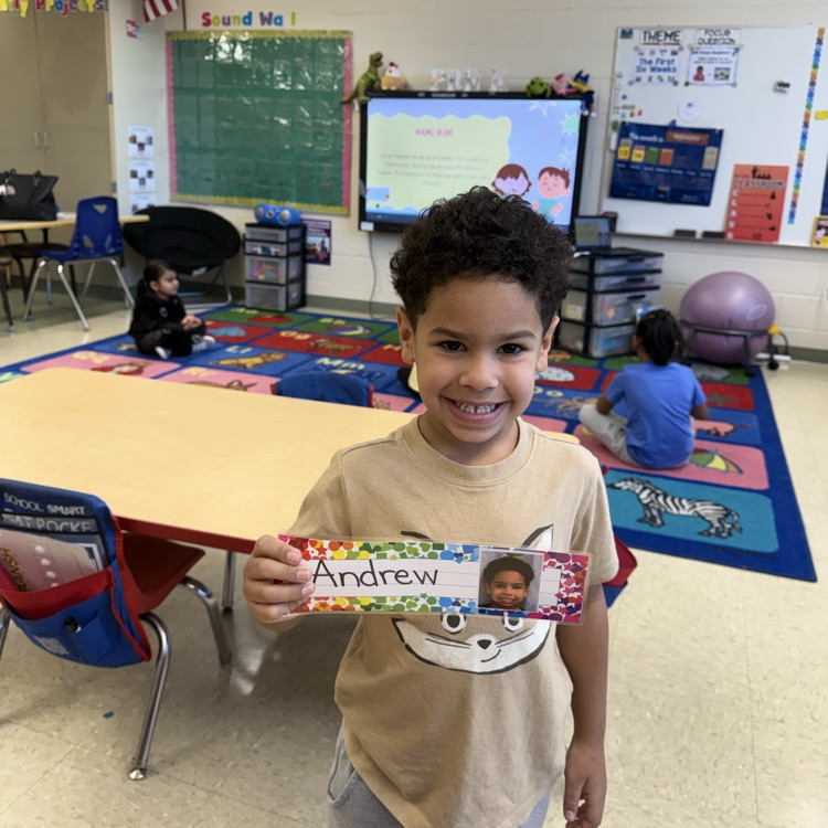 Student holding up name tag