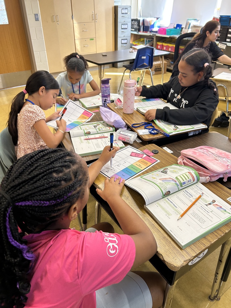 Several students are writing on organizers using dry erase markers.