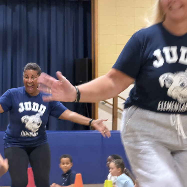 main office staff high fiving kids