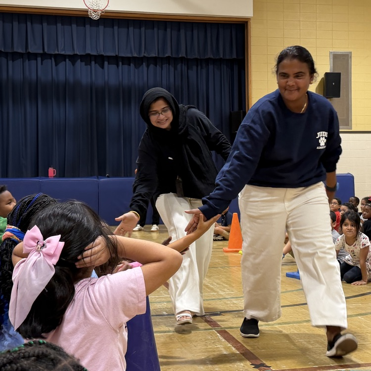 staff members high fiving kids
