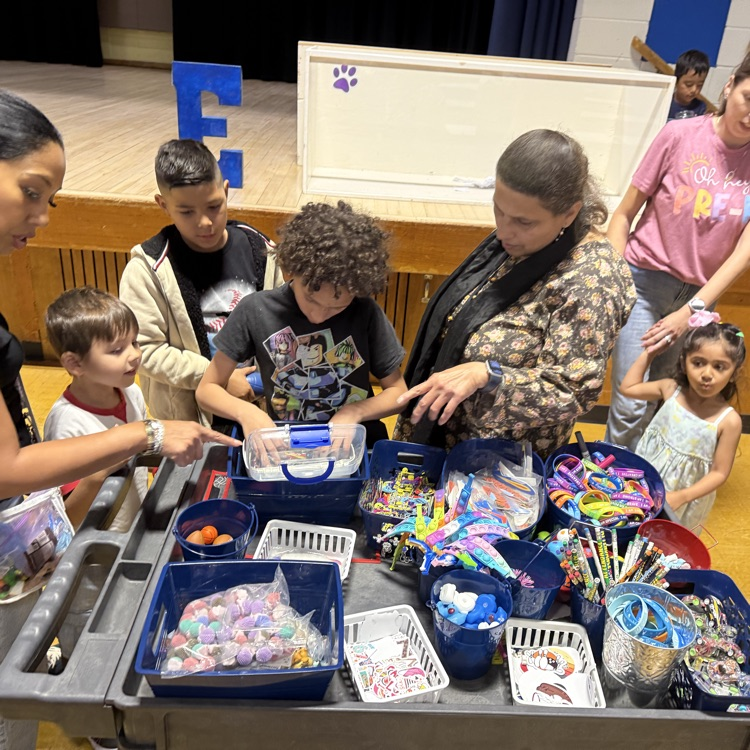 Students choosing prizes from a cart