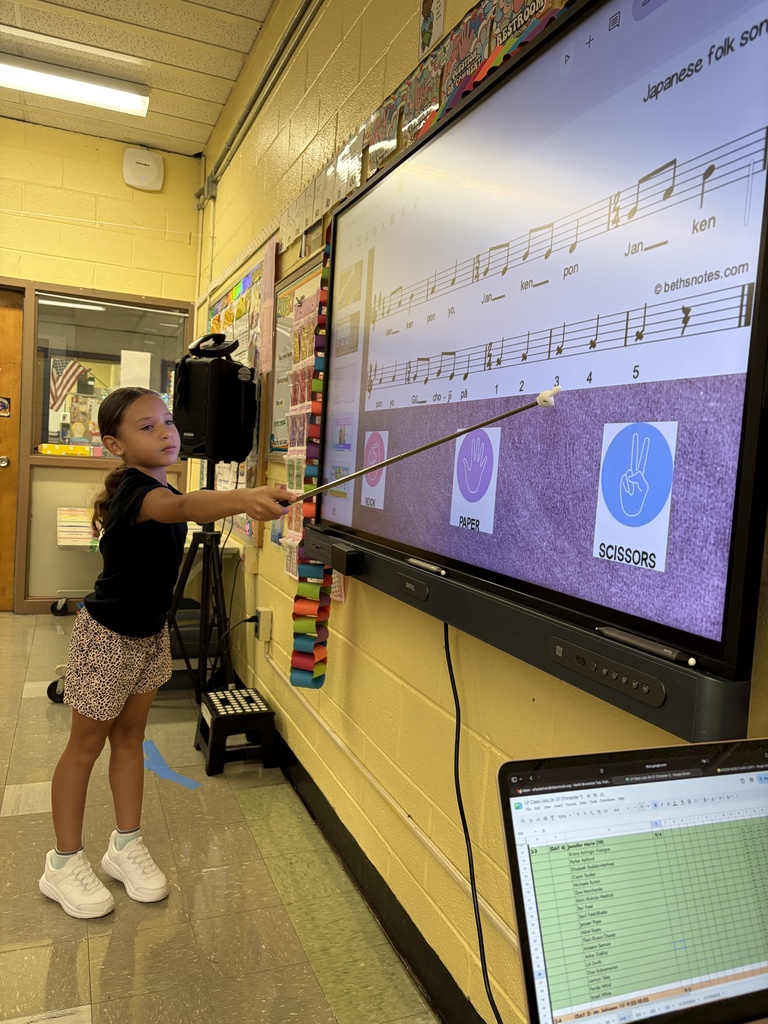 Student in music class with pointer
