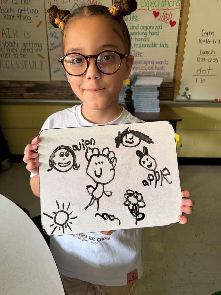 Student holding up artwork