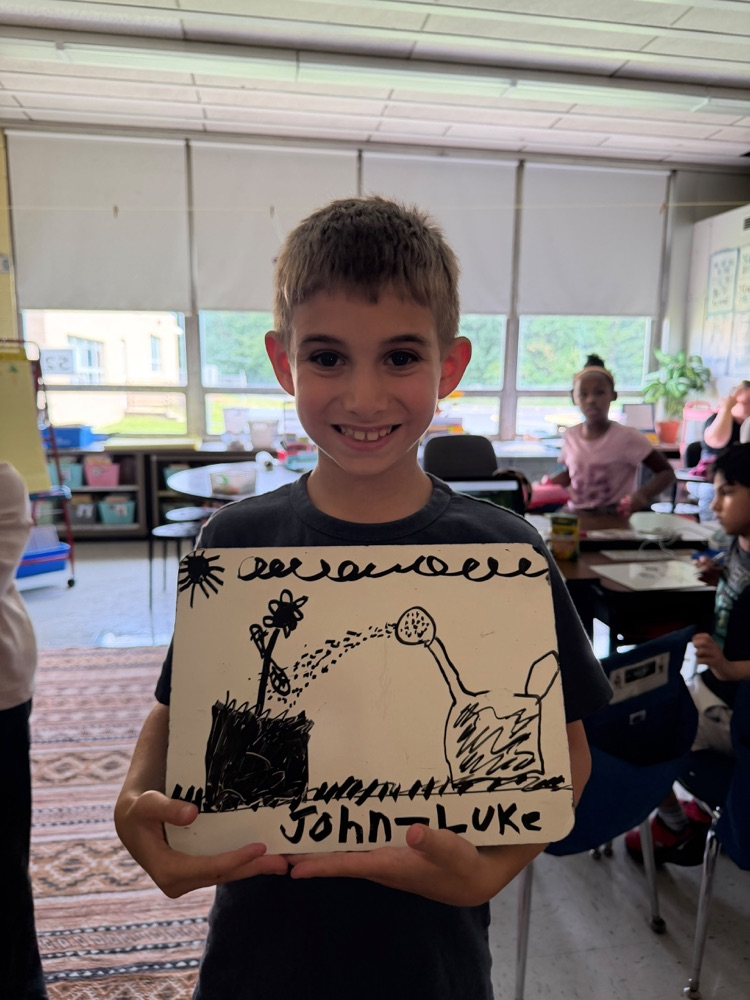 Student holding up artwork