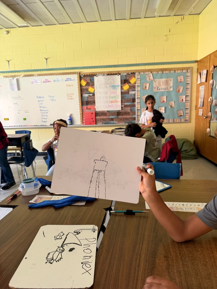 Student holding up artwork