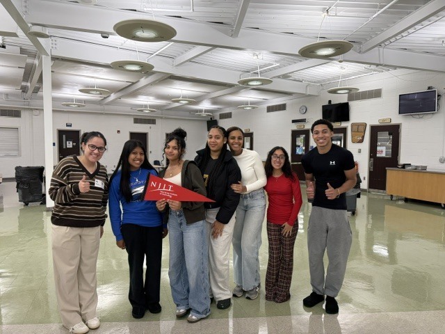 Students posing with NJIT banner