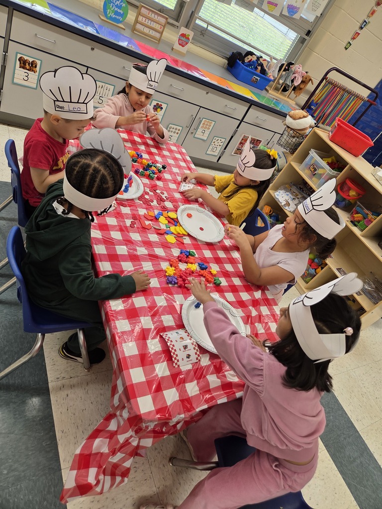 Students sitting at pretend cafe tables doing math work
