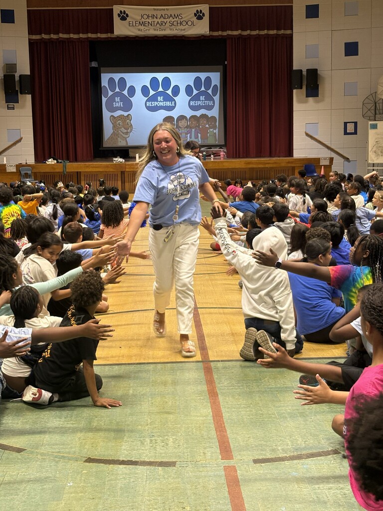 Teacher giving high fives to students