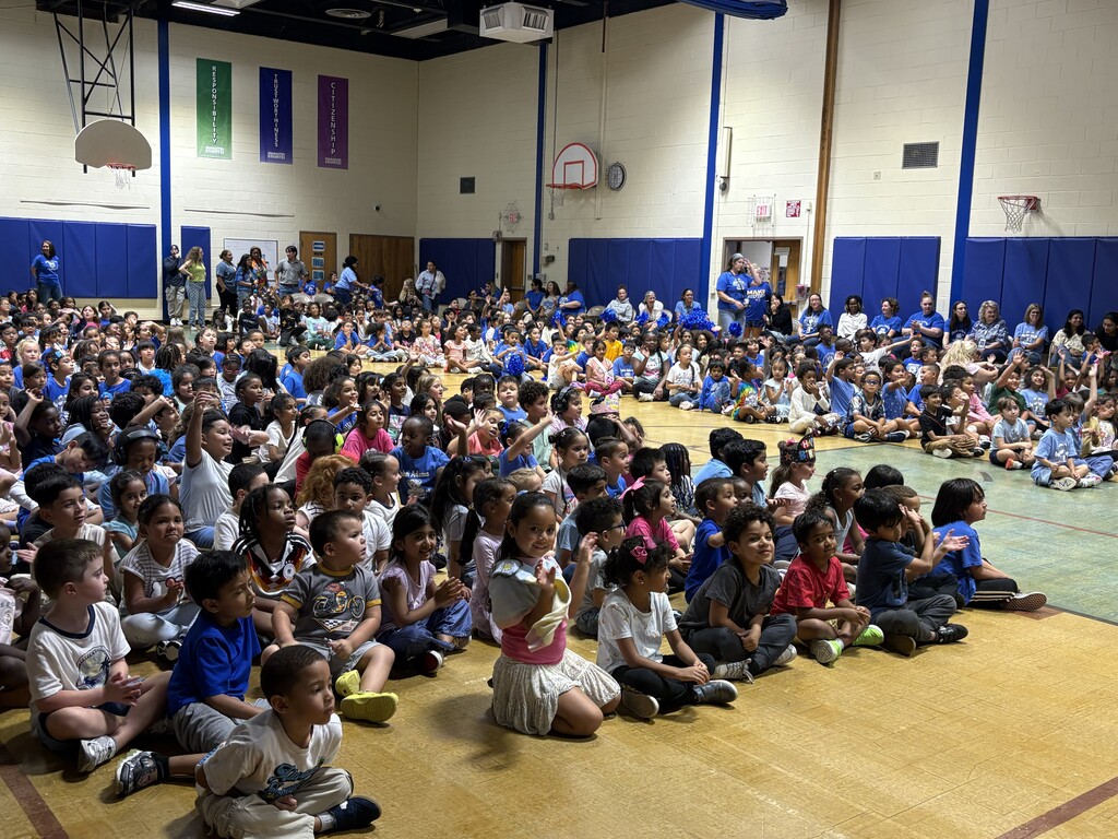 School sitting in gymnasium