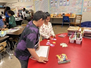 Students working on math activity at a table