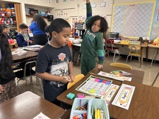 Students working on math activity at a table