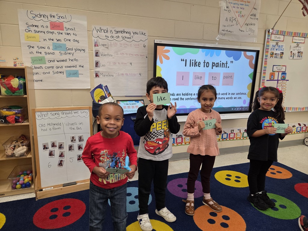 Students holding notecards that make up a sentence
