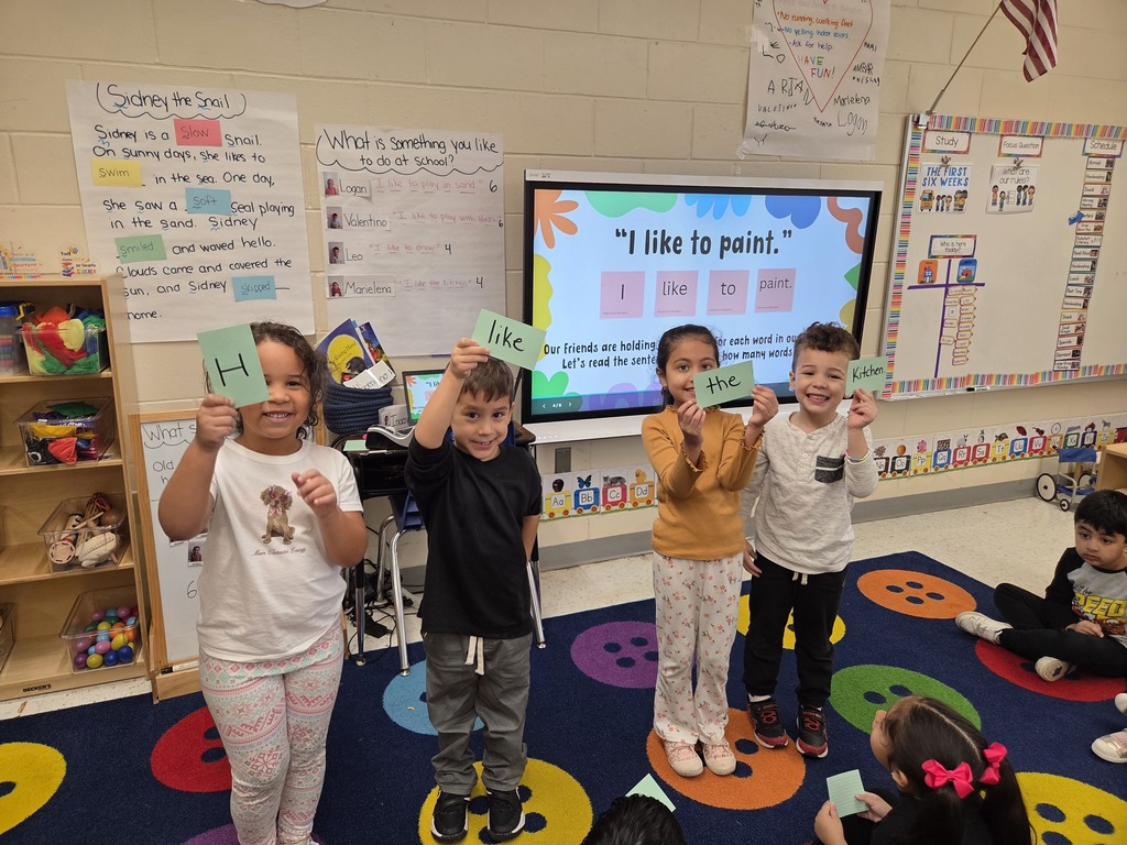 Students holding notecards that make up a sentence