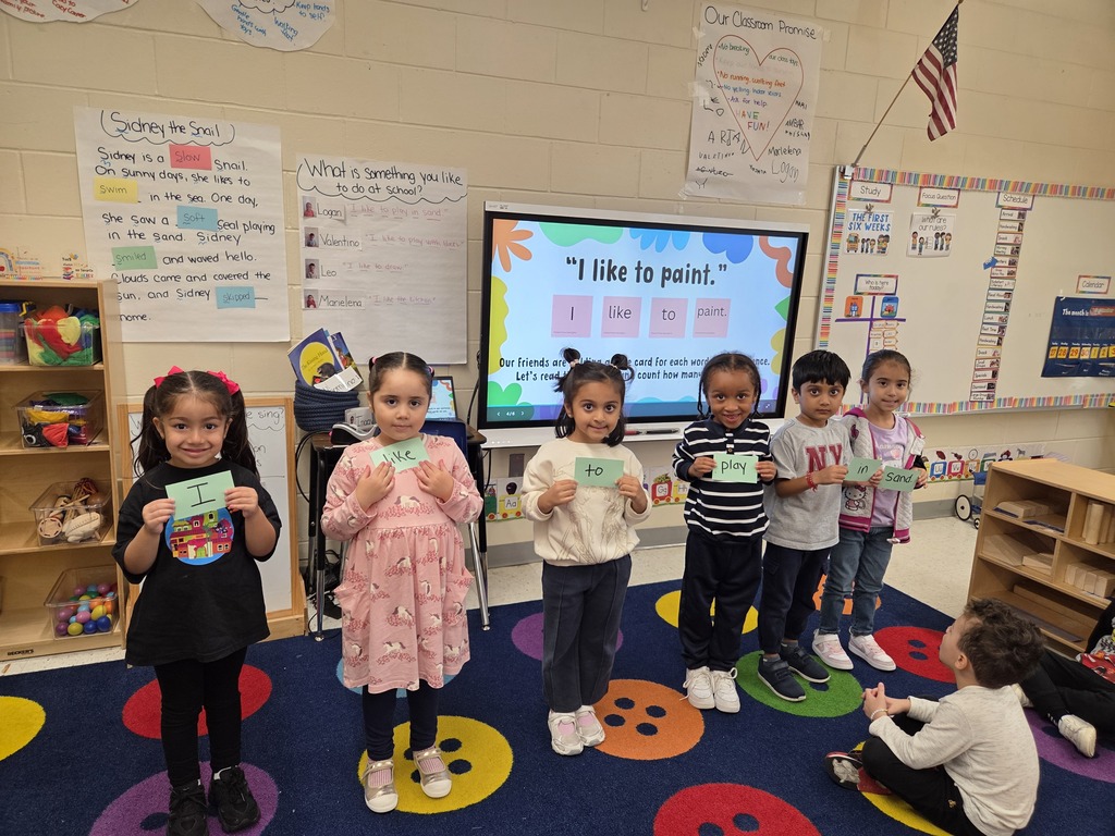 Students holding notecards that make up a sentence