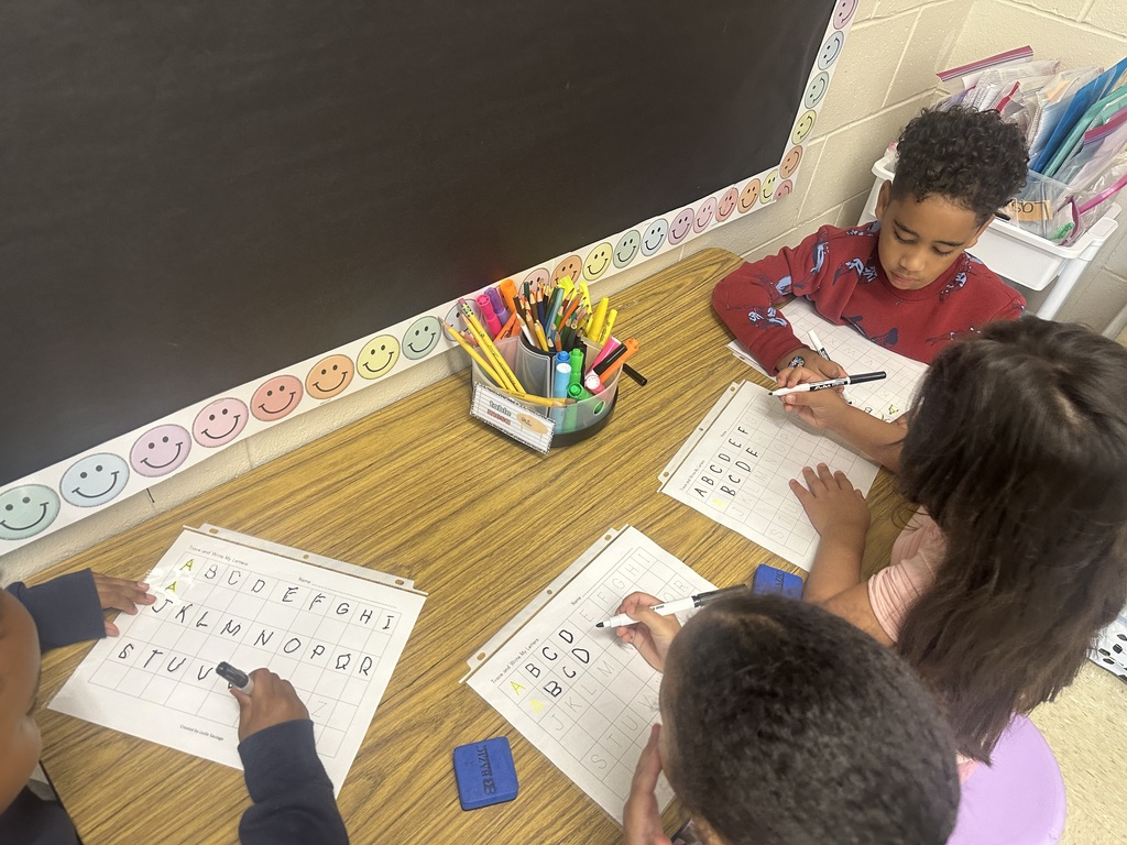 Students practicing their tracing skills with letters.