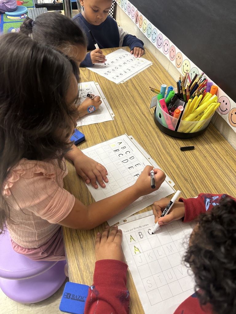 Students practicing their tracing skills with letters.