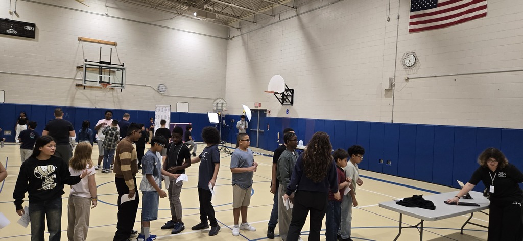 Students waiting to have their photos taken in gym