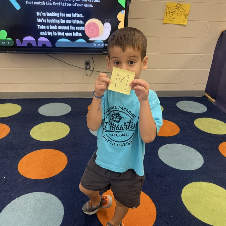 Students finding letters around the room