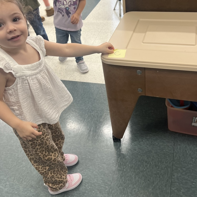 Students finding letters around the room