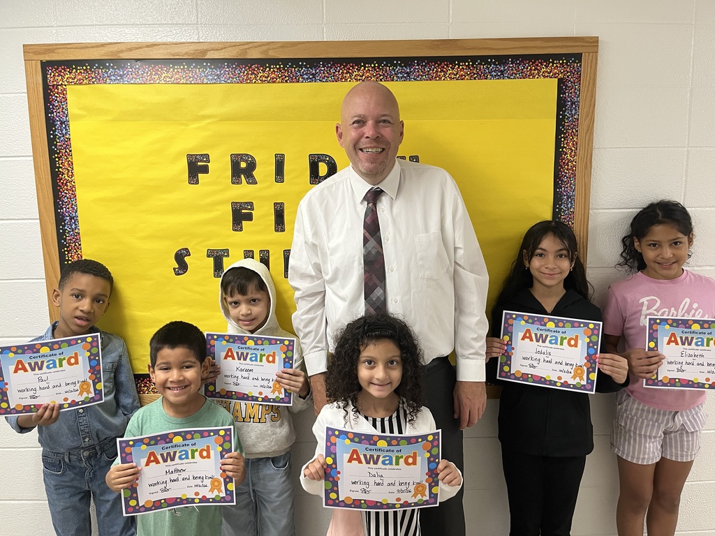 Friday Five 10/2/26: Principal Standing with students with Certificates 