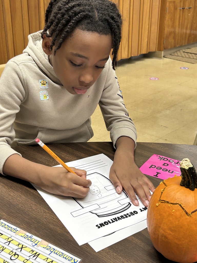 A student draws a picture of a pumpkin