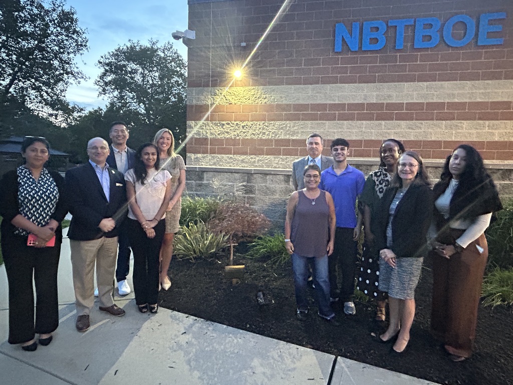 Group of people standing in front of tree memorial