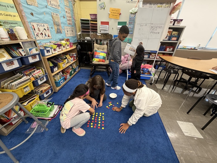 Students working together on floor as part of thinking classroom 