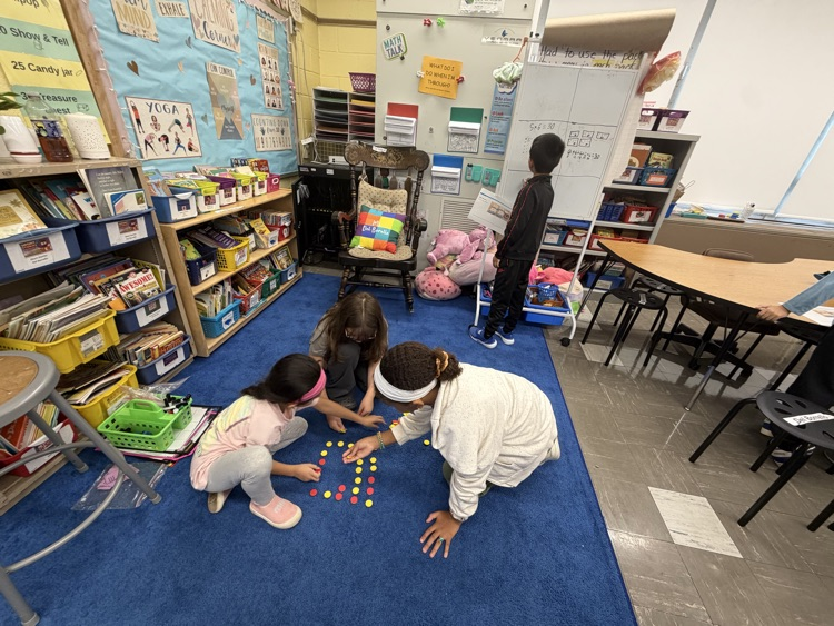 Students working together on floor as part of thinking classroom 