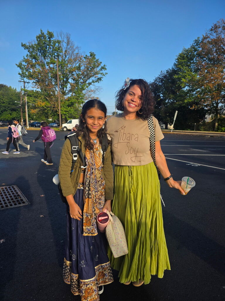 Teacher and student posing together