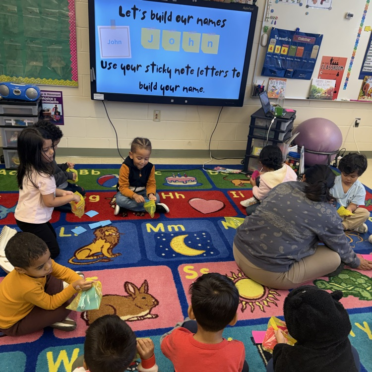 Students learning on the carpet