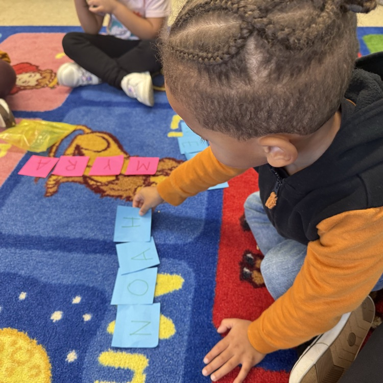Students learning together on the carpet with post its