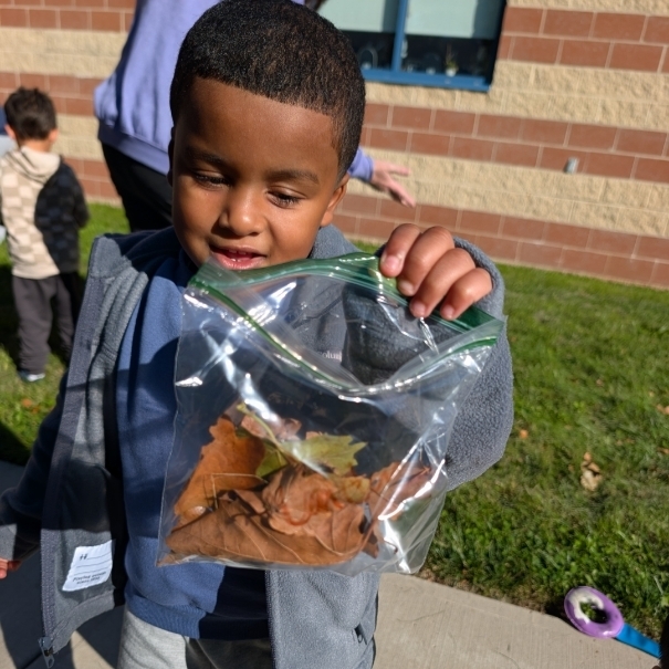 Student holding leaves