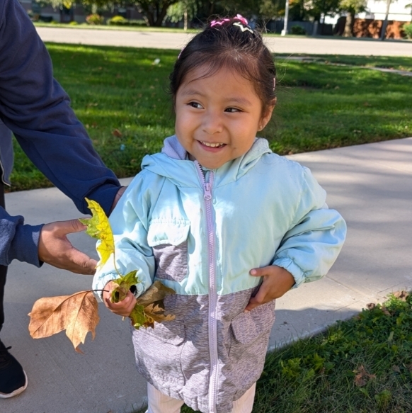 Student holding leaves.